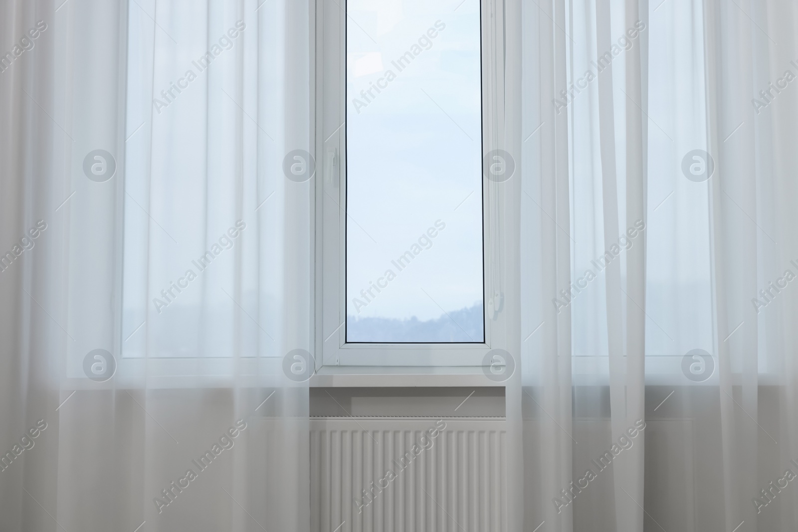 Photo of Window with elegant white curtains indoors. Interior design