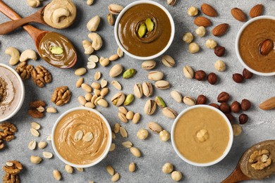 Tasty nut butters and raw nuts on light grey table, flat lay