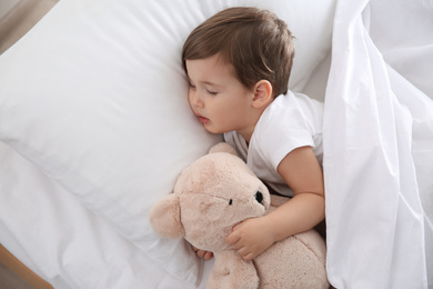 Cute little baby sleeping with toy at home. Bedtime