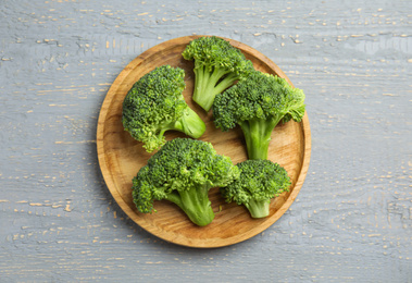 Fresh green broccoli on wooden table, top view