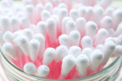Photo of Many cotton buds in glass jar, closeup