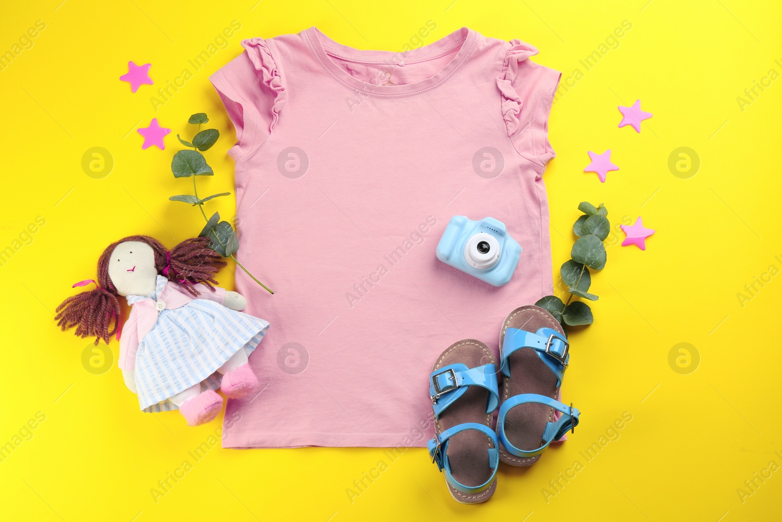 Photo of Flat lay composition with toy camera for little photographer on yellow background