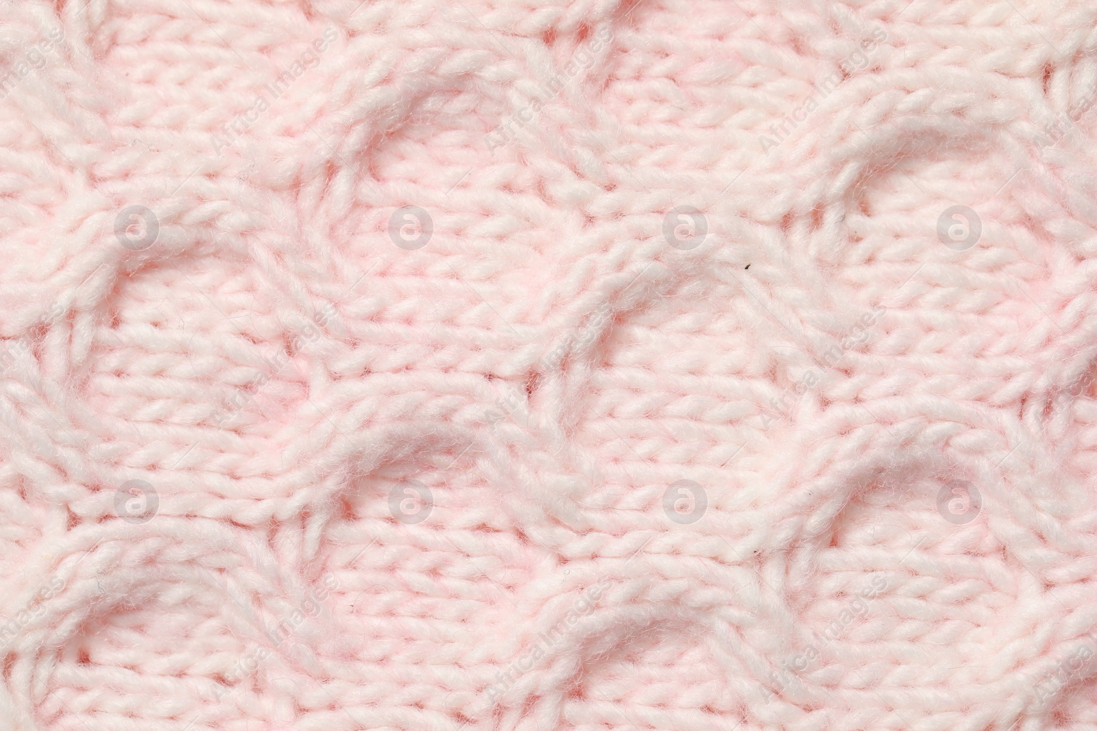 Photo of Texture of soft pink knitted fabric as background, top view