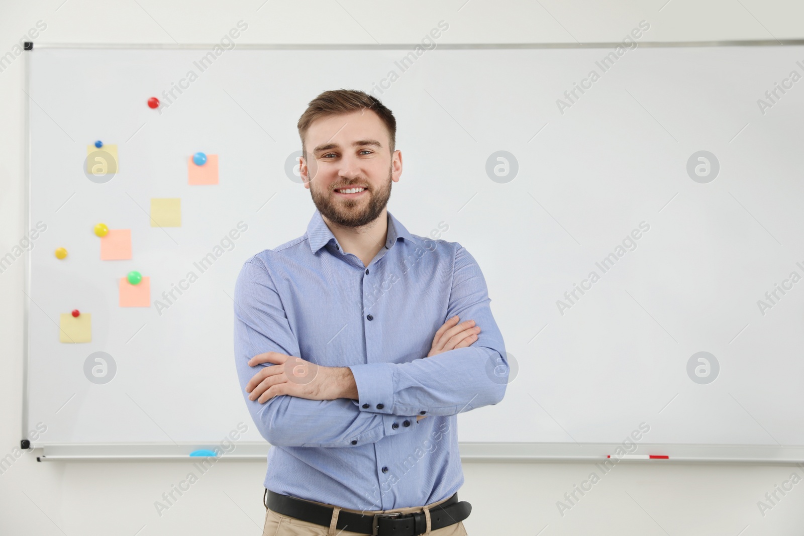 Photo of Portrait of young teacher near whiteboard in classroom