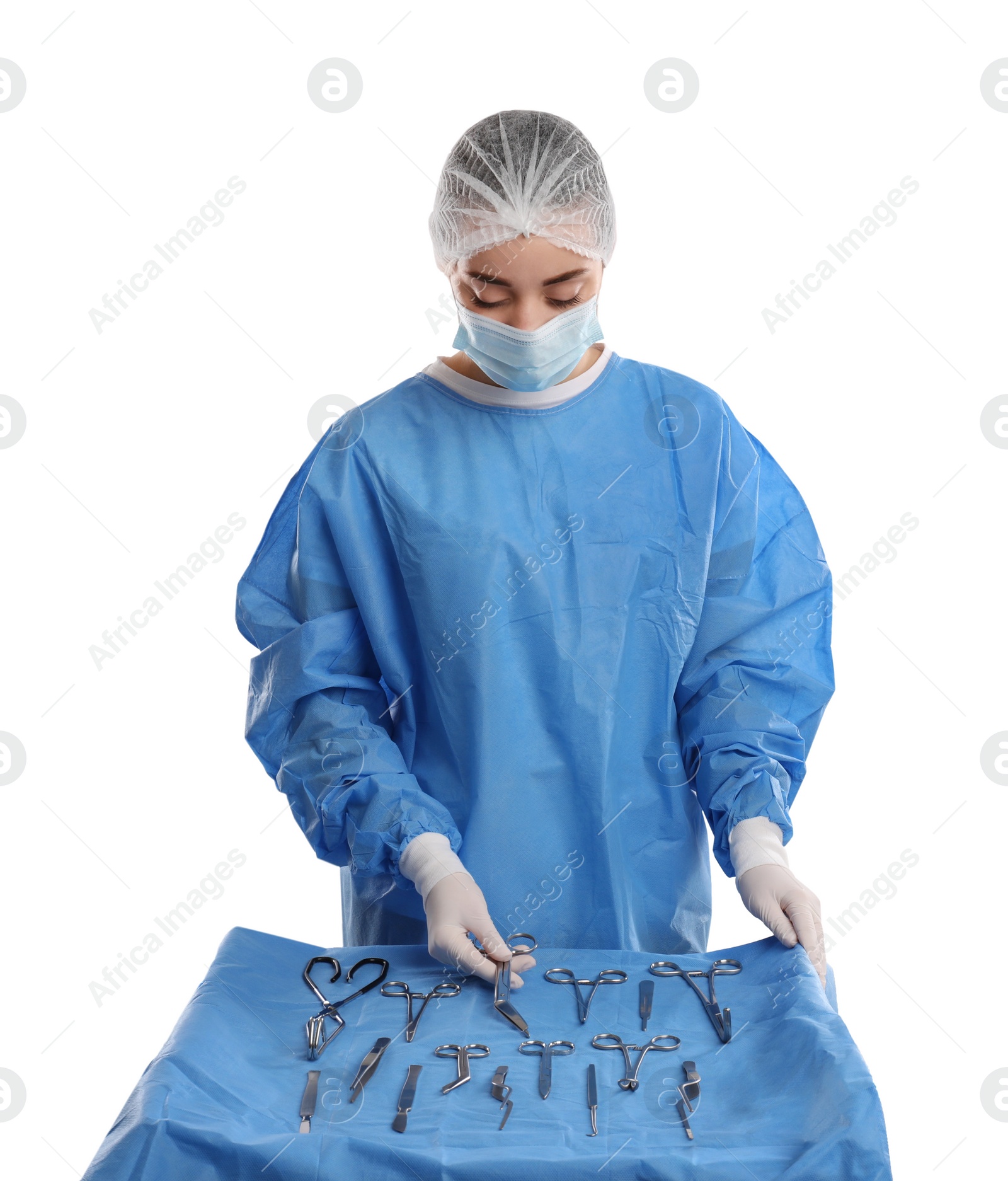 Photo of Doctor holding Pott's scissors near table with different surgical instruments on light background