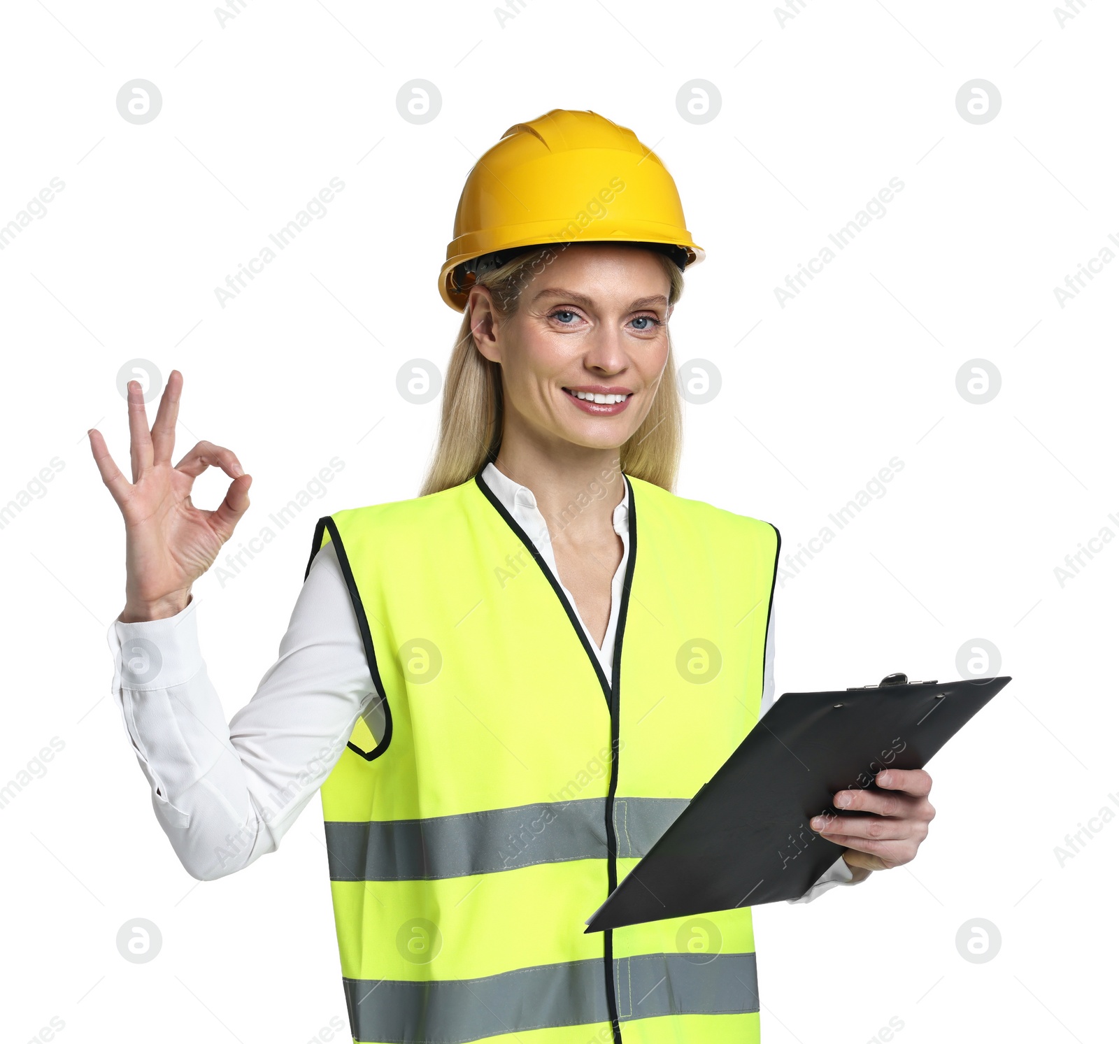 Photo of Engineer in hard hat holding clipboard and showing ok gesture on white background