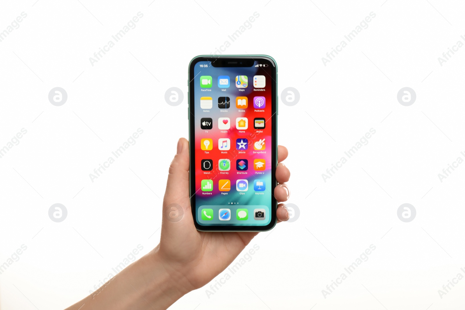 Photo of MYKOLAIV, UKRAINE - JULY 9, 2020: Woman holding  iPhone X with home screen on white background, closeup