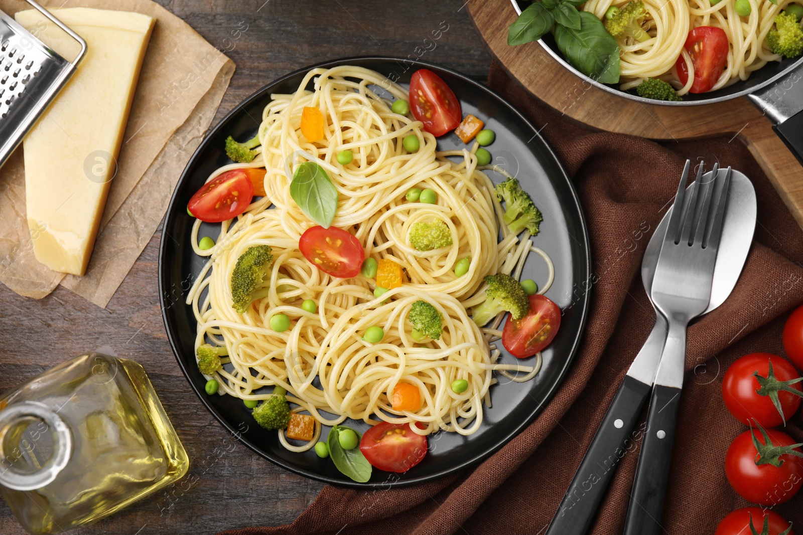 Photo of Flat lay composition with delicious pasta primavera on wooden table