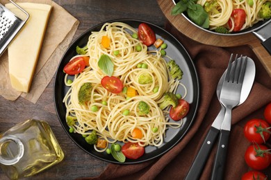 Photo of Flat lay composition with delicious pasta primavera on wooden table