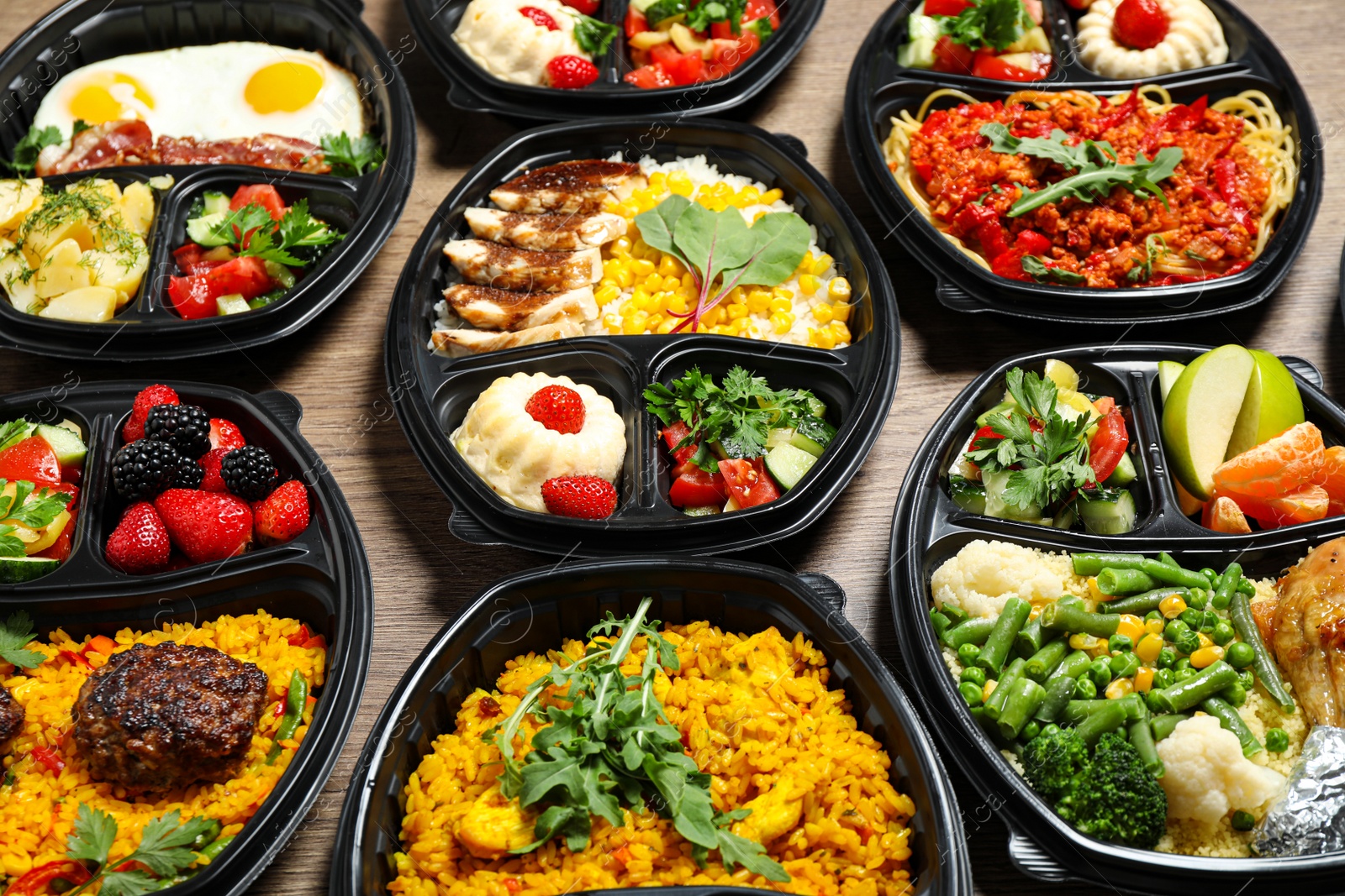 Photo of Lunchboxes with different meals on table. Healthy food delivery