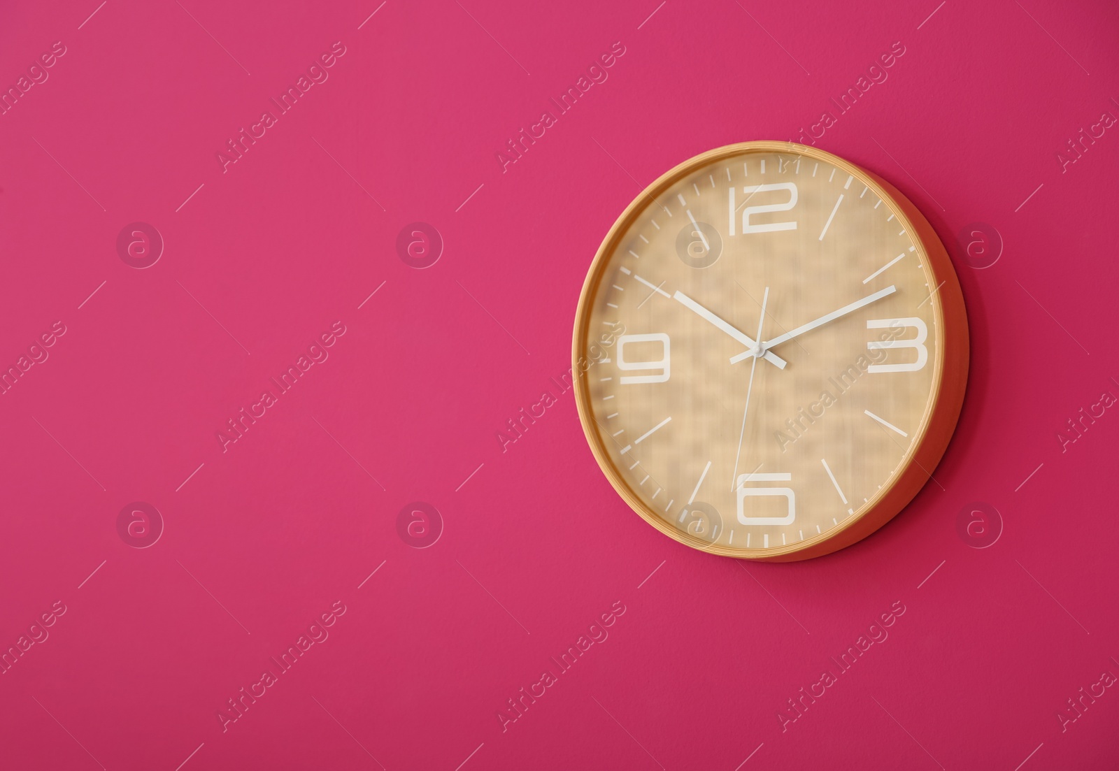 Photo of Stylish clock on color wall. Time concept