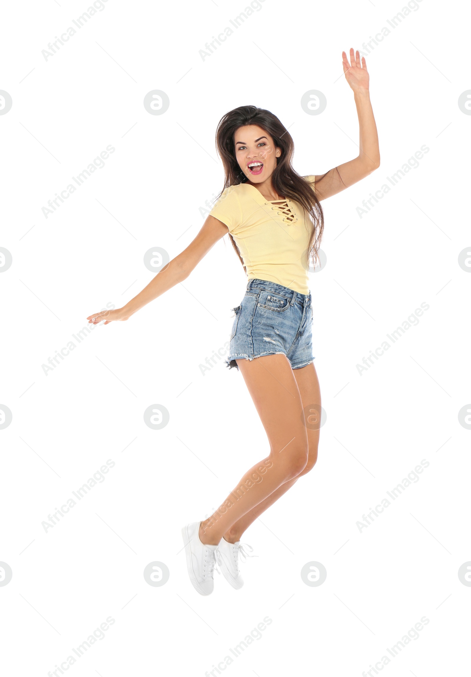 Photo of Beautiful woman in casual clothes jumping on white background