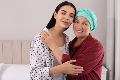 Young woman visiting her mother with cancer indoors