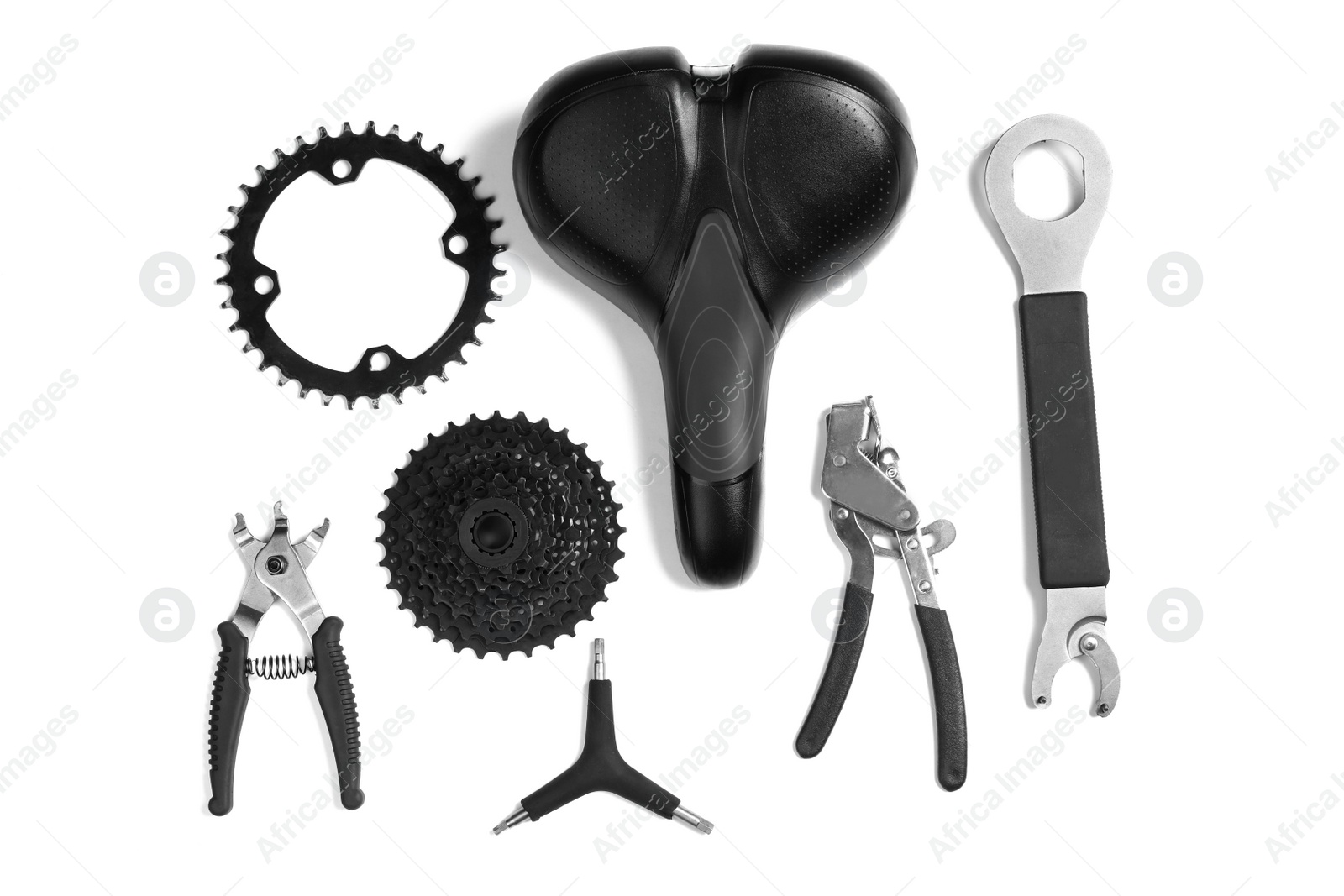 Photo of Set of different bicycle tools and parts on white background, flat lay