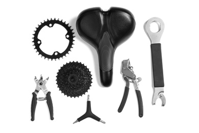 Photo of Set of different bicycle tools and parts on white background, flat lay