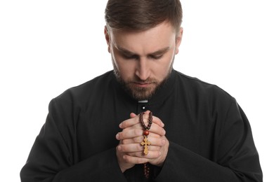 Priest with rosary beads praying on white background