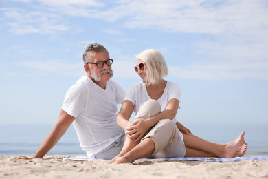 Photo of Mature couple spending time together on sea beach