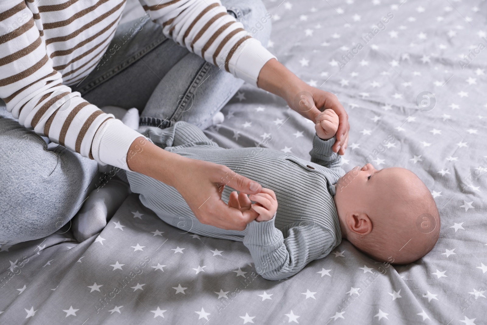 Photo of Mother and her little baby on bed, closeup