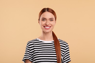 Photo of Beautiful woman with clean teeth smiling on beige background