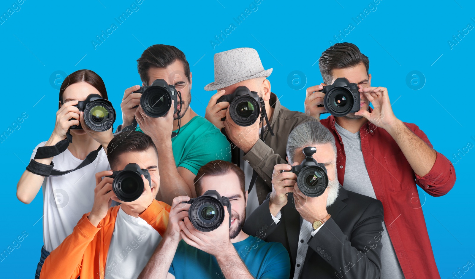 Image of Group of professional photographers with cameras on turquoise background