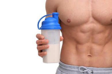 Young man with muscular body holding shaker of protein on white background, closeup