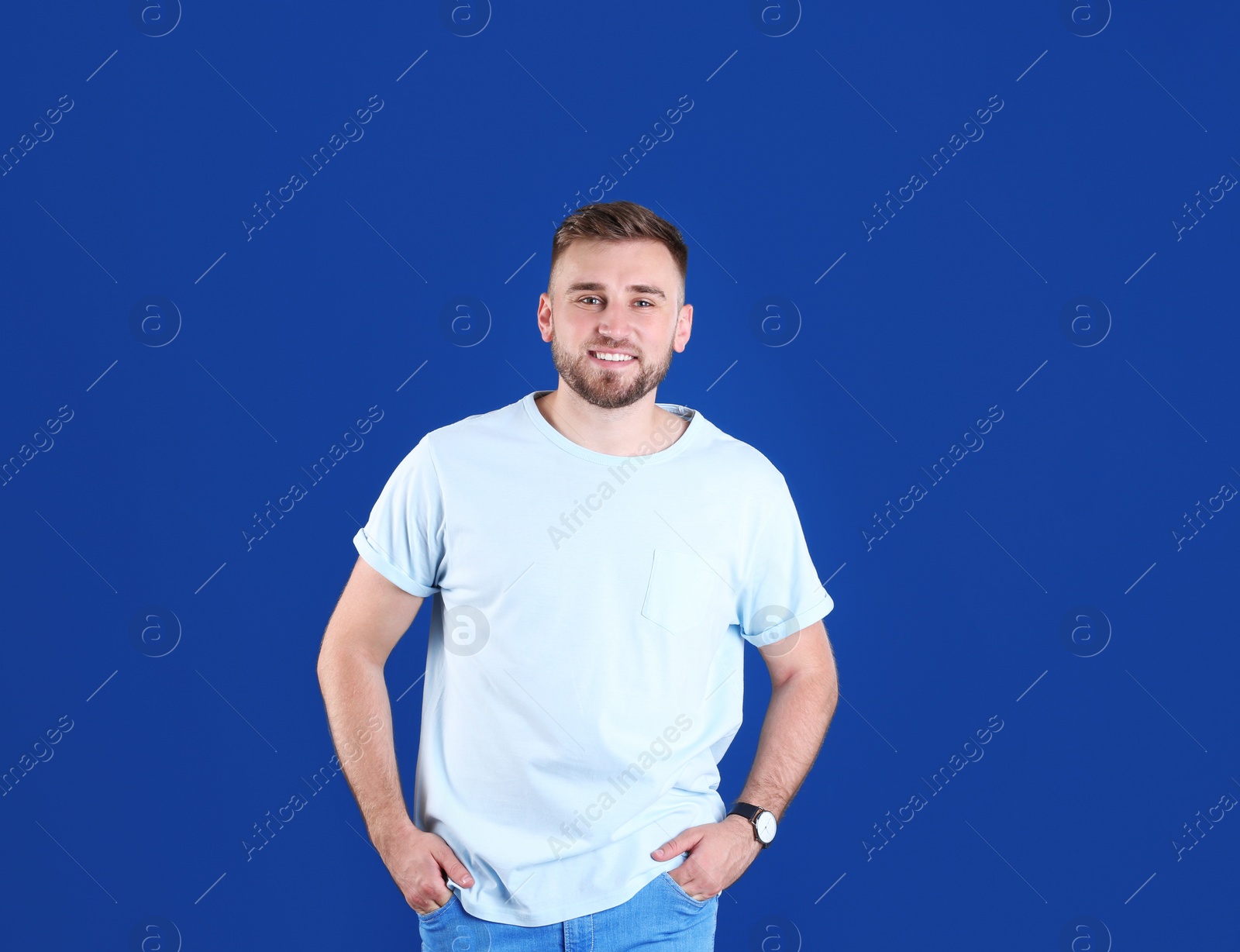 Photo of Portrait of handsome happy man on color background