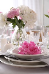 Photo of Stylish table setting with beautiful peonies in dining room, closeup. Space for text