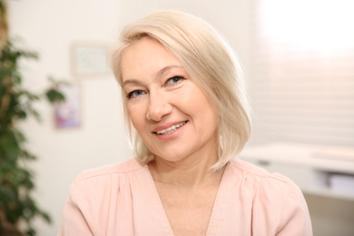 Portrait of beautiful mature woman at home