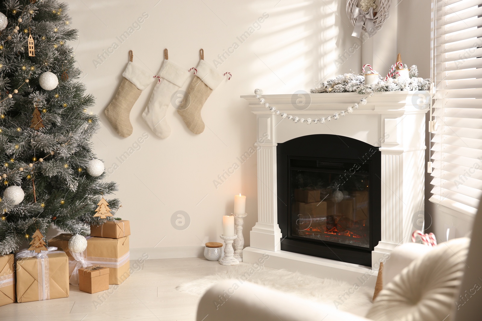 Photo of Beautiful living room interior with decorated Christmas tree and modern fireplace