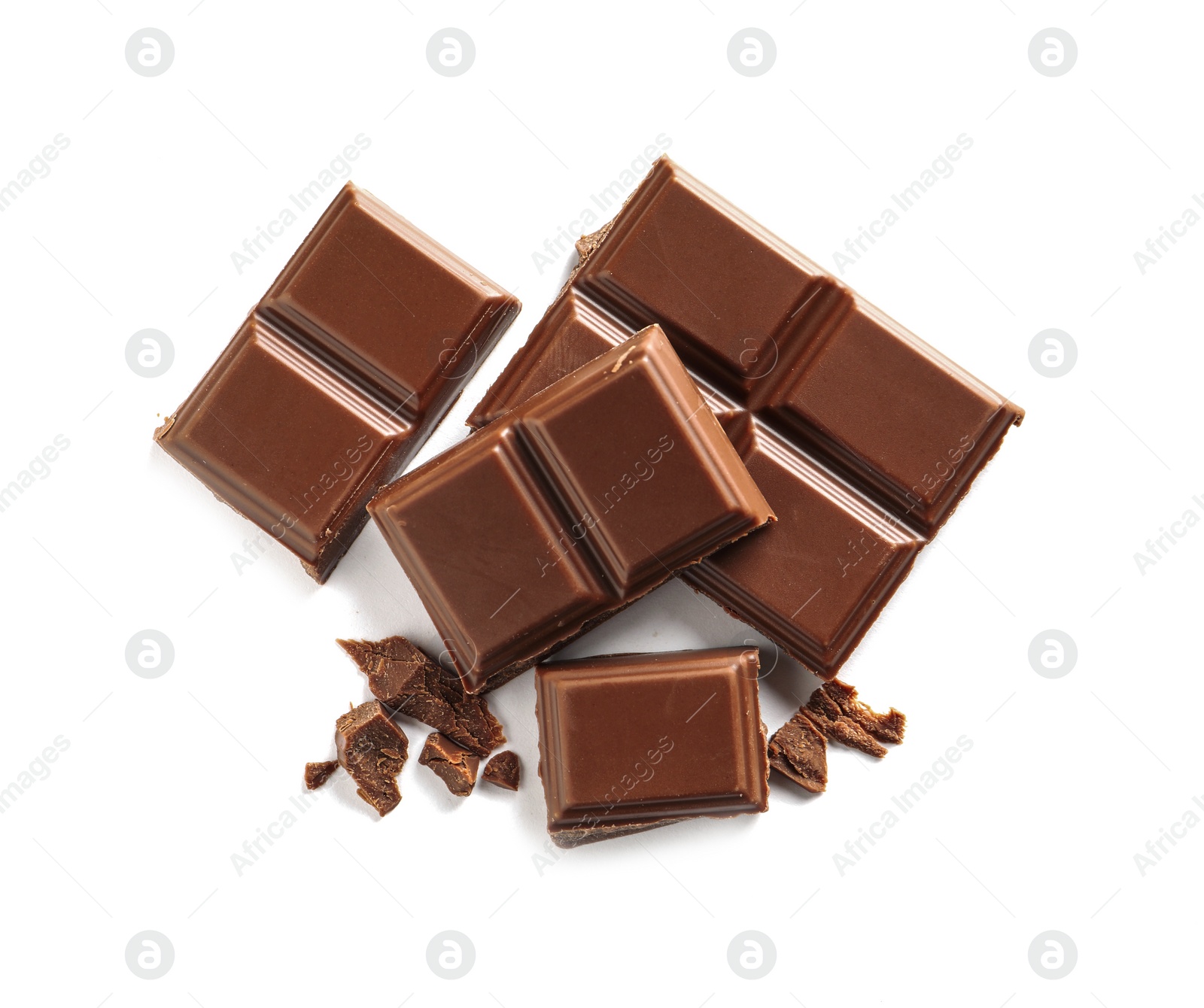 Photo of Pieces of tasty milk chocolate on white background, top view