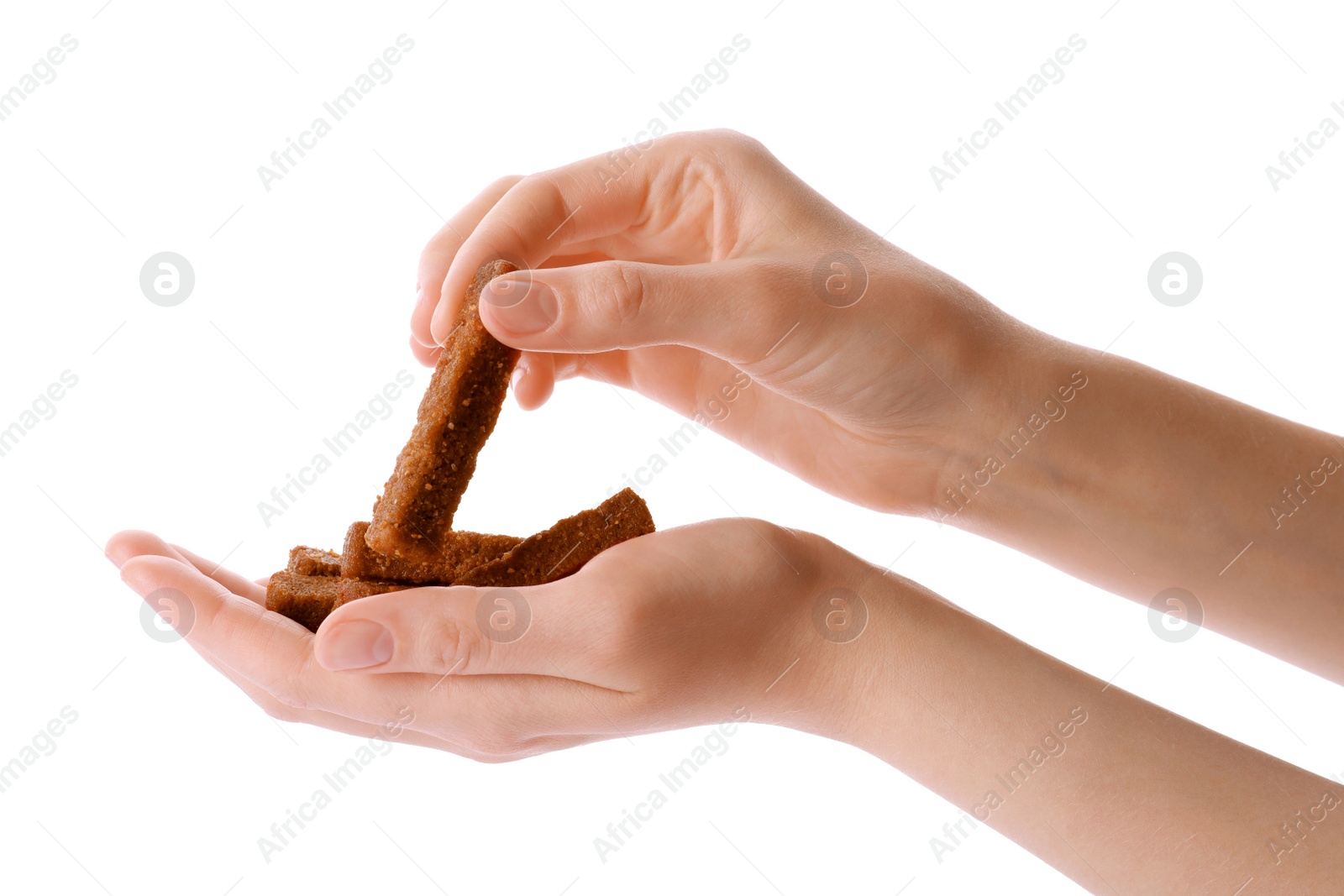 Photo of Woman holding crispy rusks on white background, closeup