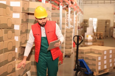 Man with tablet working at warehouse. Logistics center