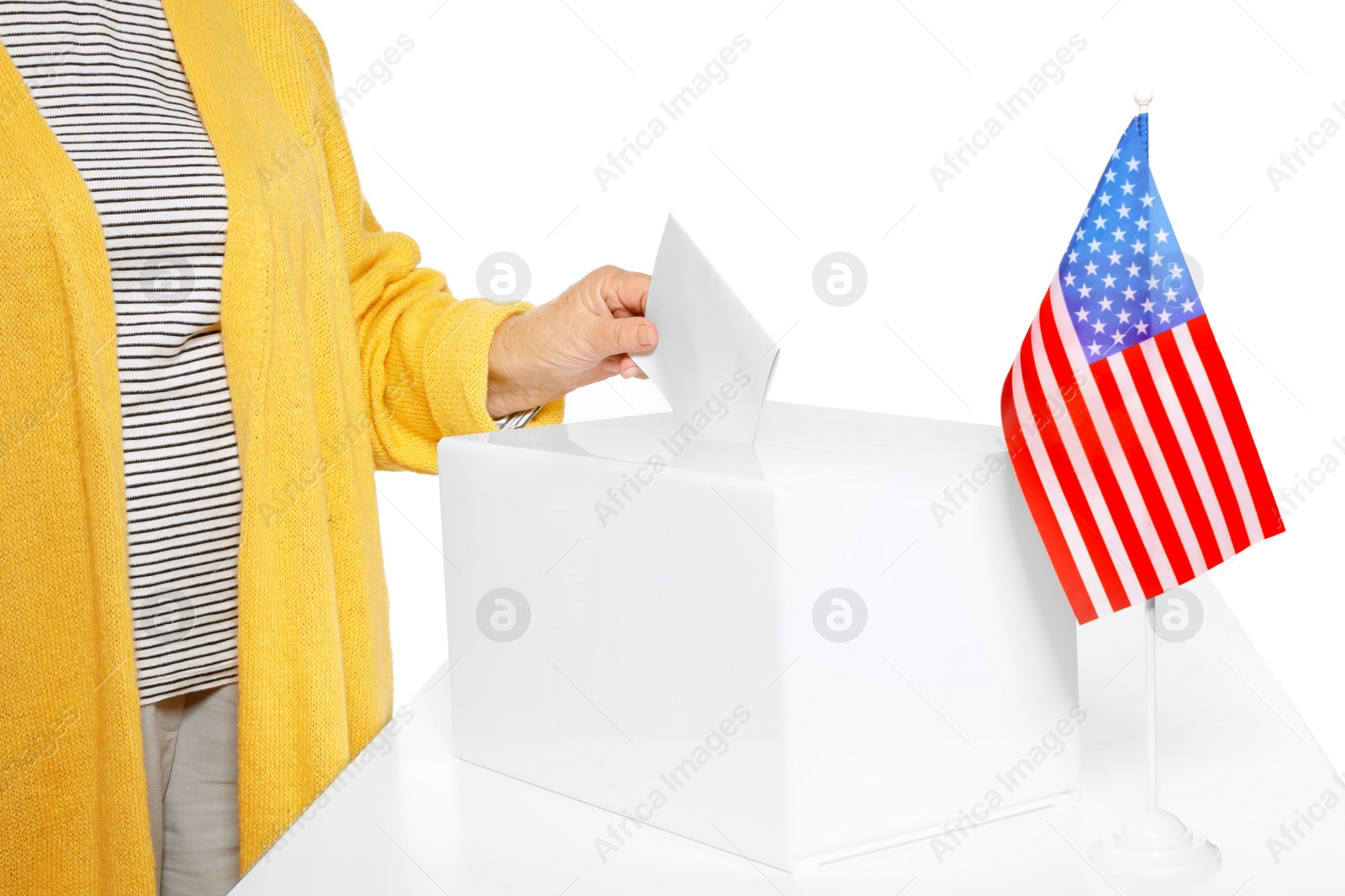 Photo of Elderly woman putting ballot paper into box against white background, closeup