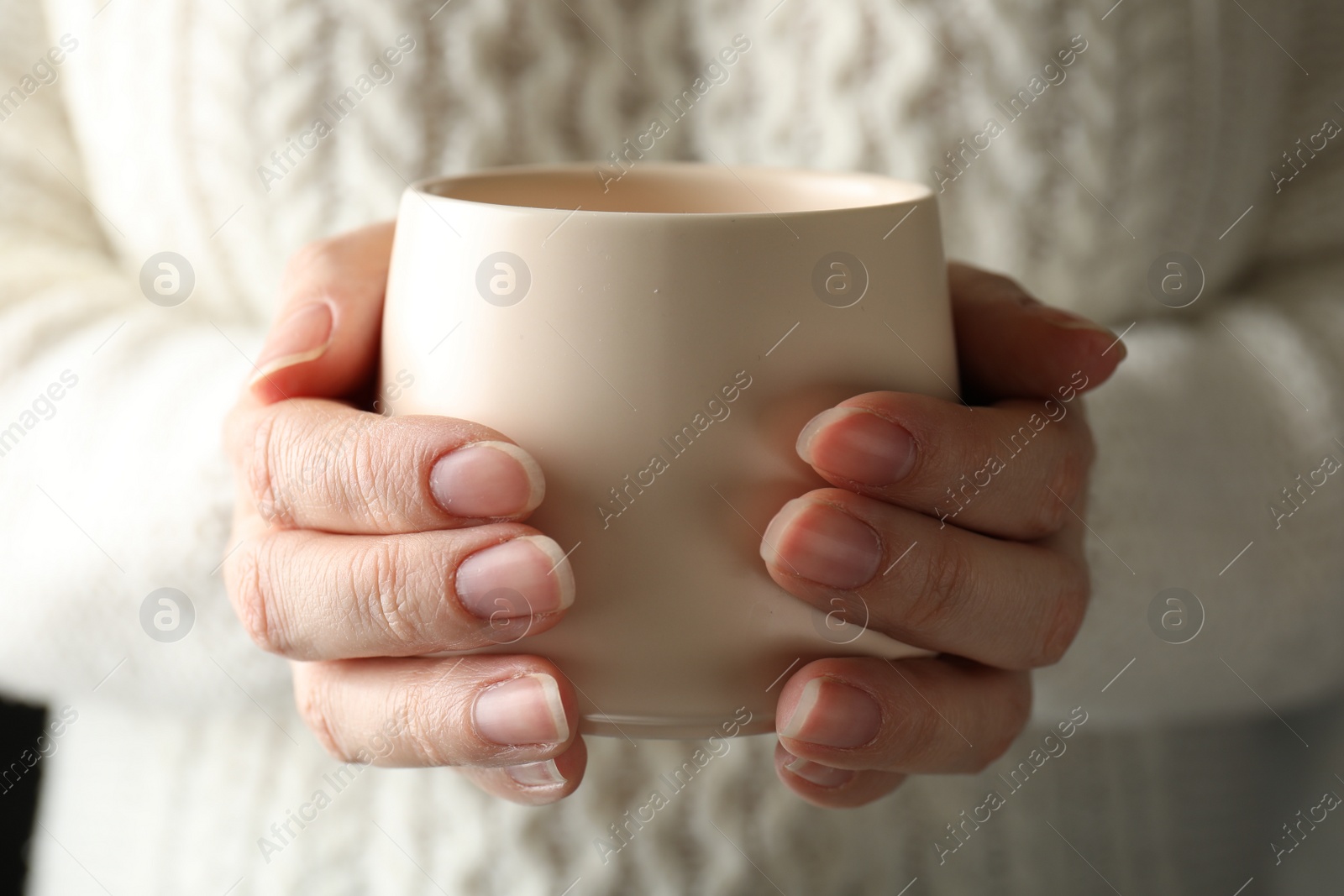 Photo of Woman holding cup of hot winter drink, closeup