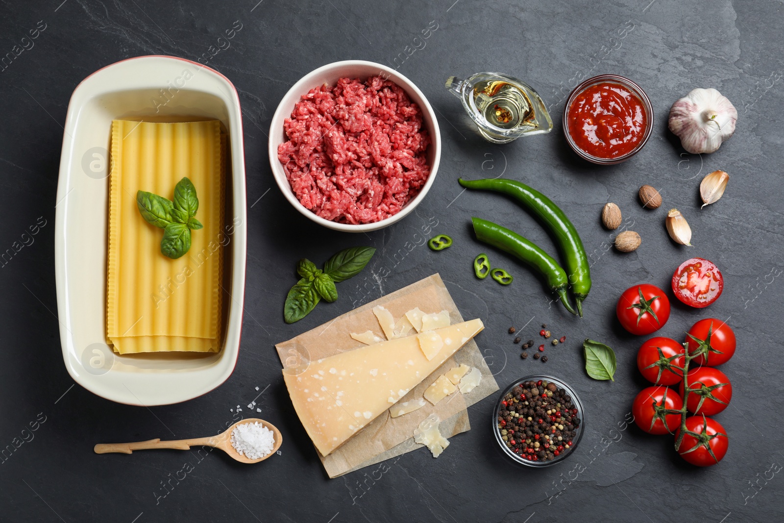 Photo of Fresh ingredients for lasagna on black table, flat lay
