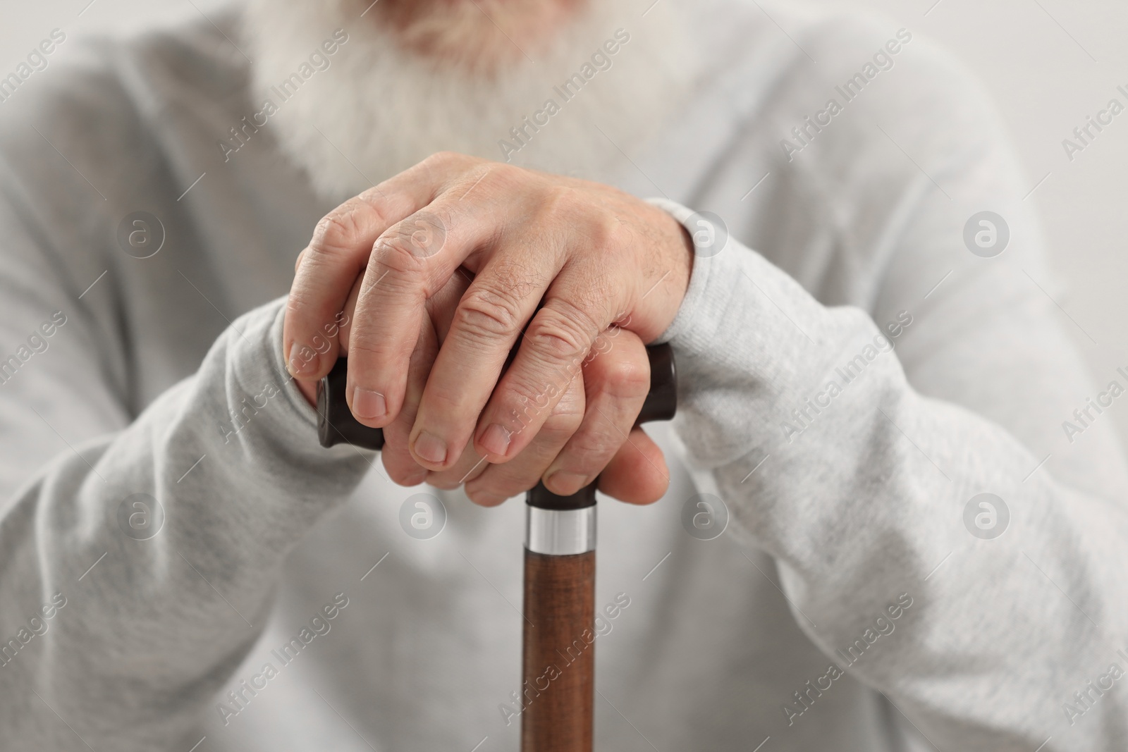 Photo of Senior man with walking cane, closeup view