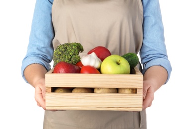 Photo of Woman holding wooden crate filled with fresh vegetables and fruits against white background, closeup