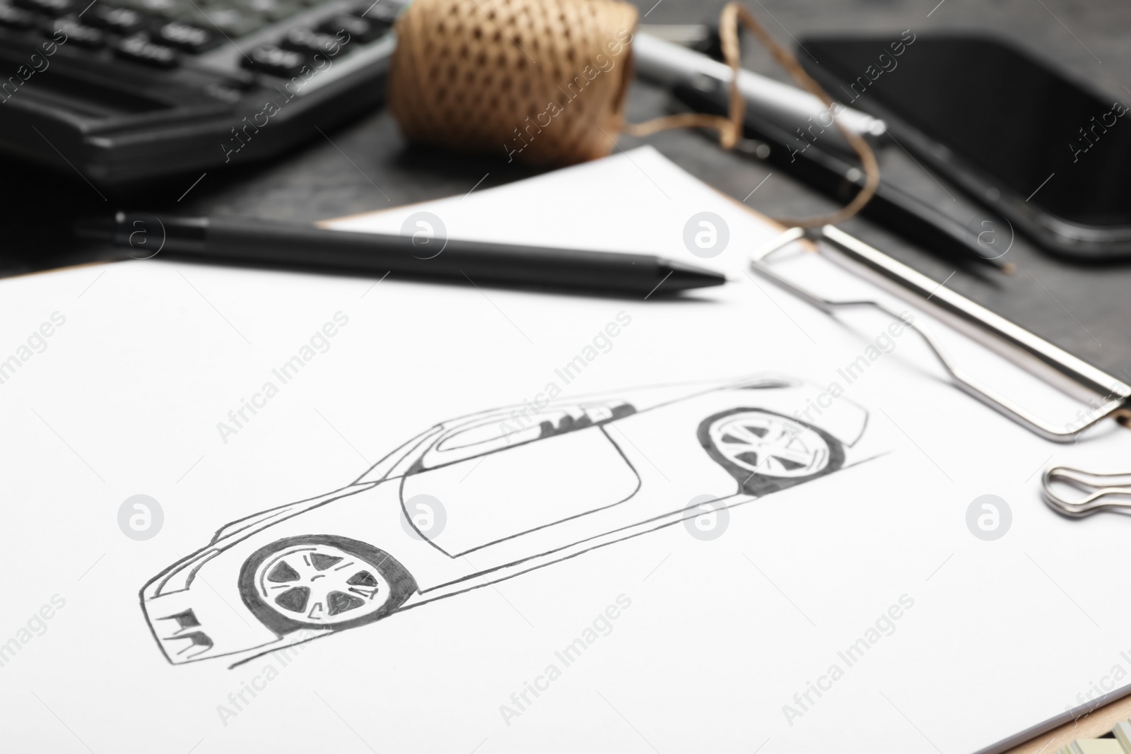 Photo of Drawing of car on table, closeup. Designer's workplace