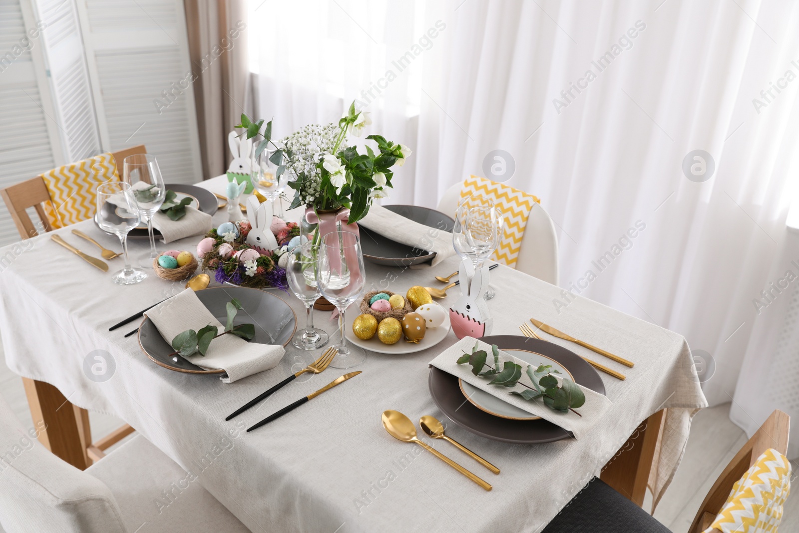 Photo of Beautiful Easter table setting with festive decor indoors