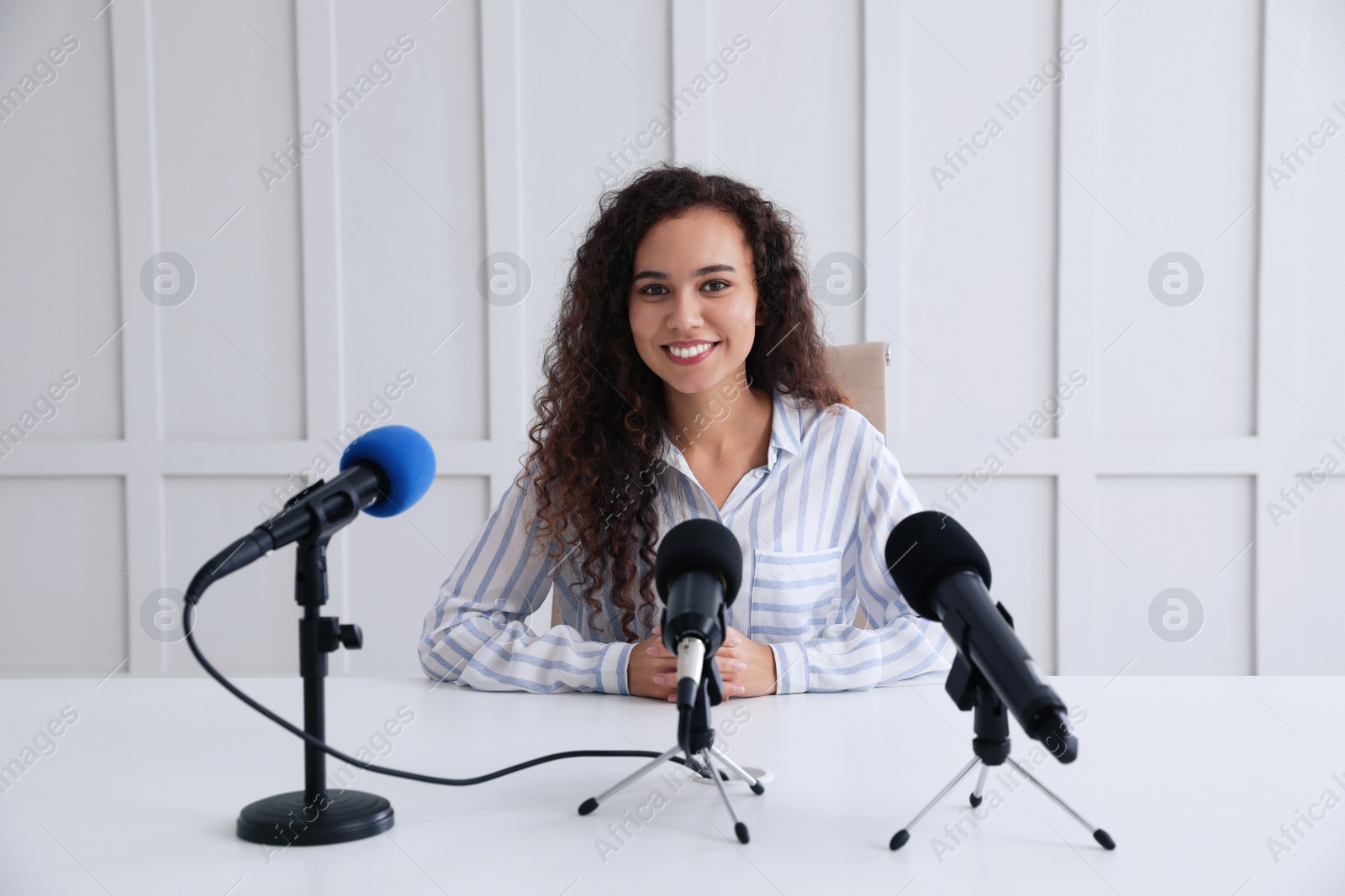 Photo of Happy African American woman giving interview at official event