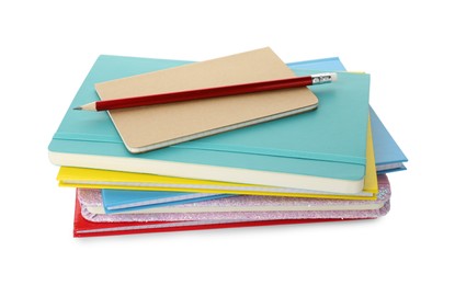 Photo of Stack of different colorful hardcover planners and pencil on white background