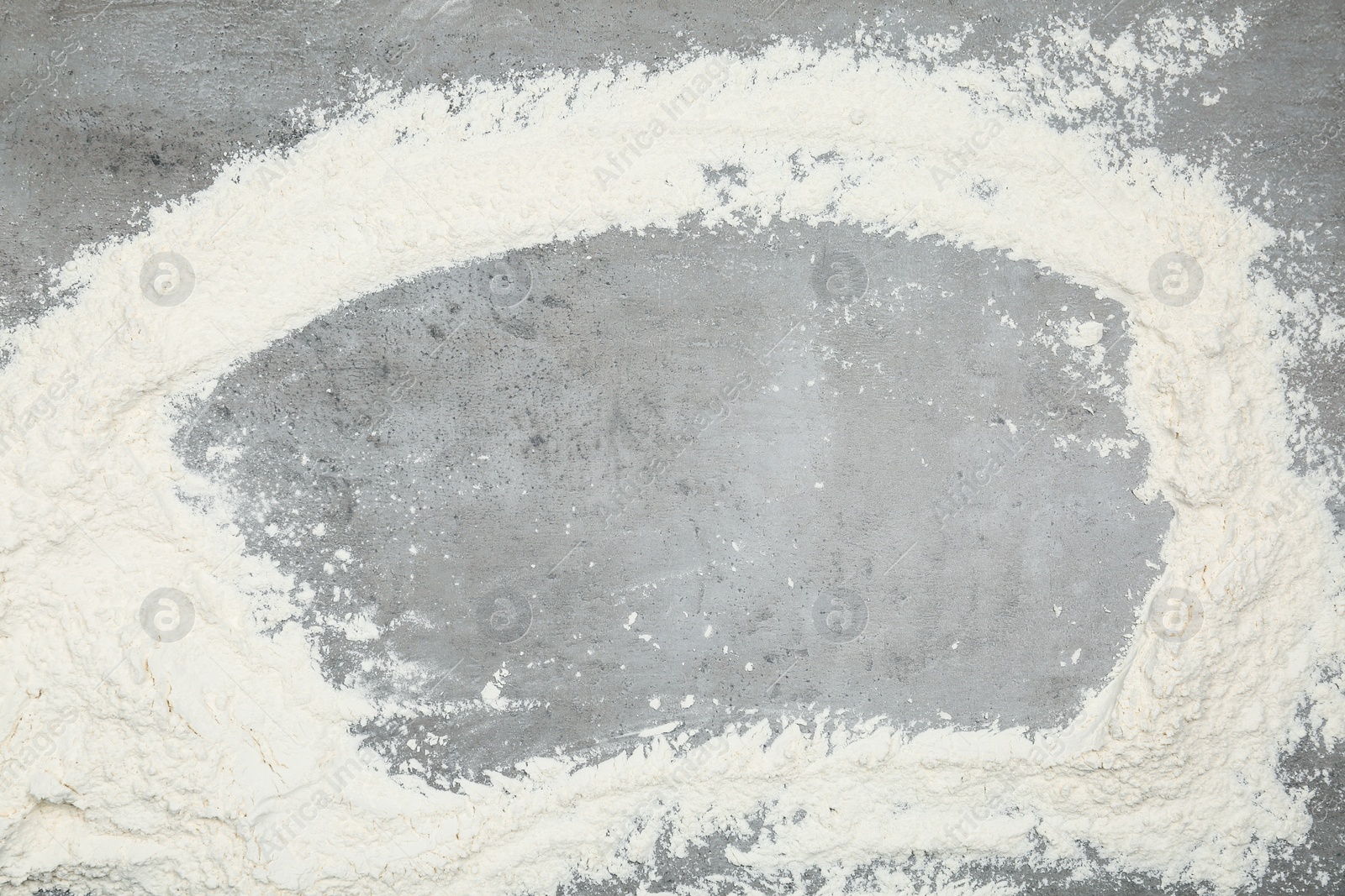 Photo of Frame made with flour on light grey table, top view. Space for text
