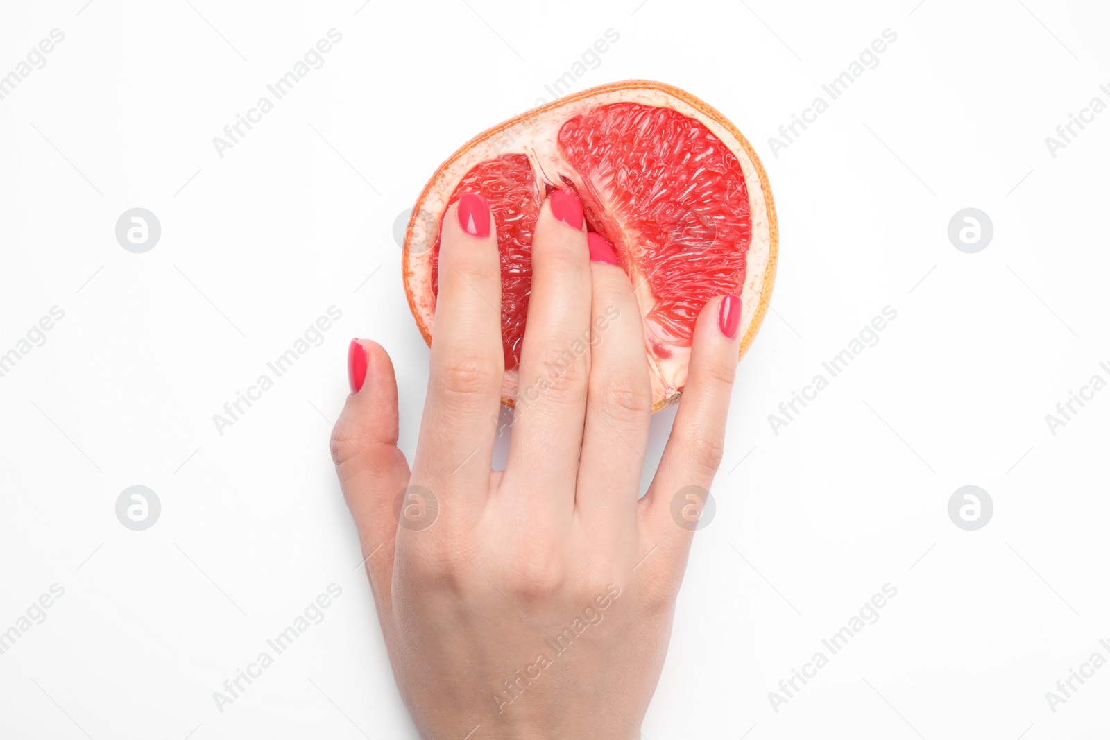 Photo of Young woman touching half of grapefruit on white background, top view. Sex concept