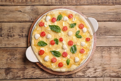 Photo of Fresh tasty homemade pizza on wooden background, top view