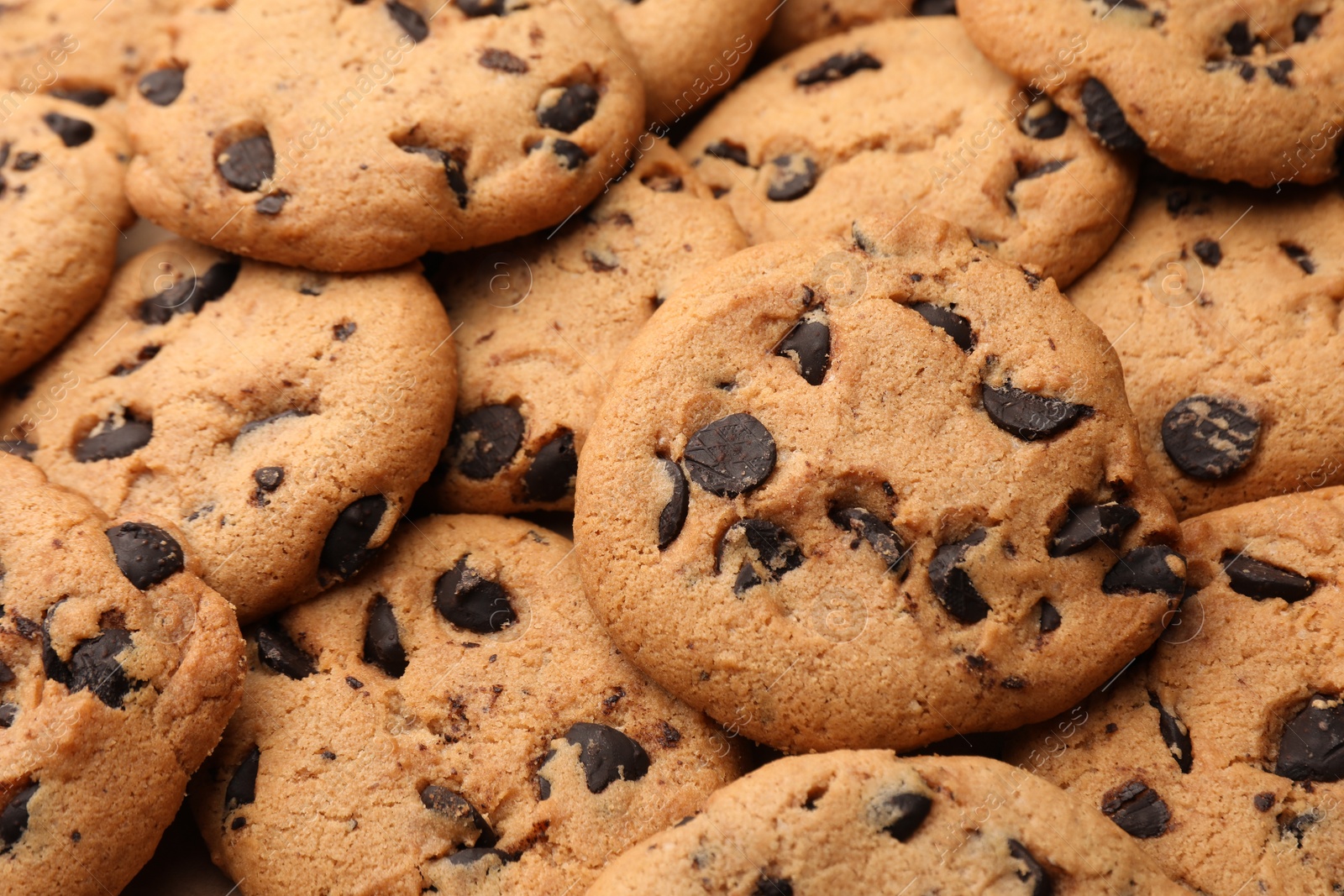 Photo of Delicious chocolate chip cookies as background, closeup