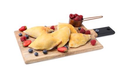 Photo of Wooden board with delicious samosas and berries isolated on white