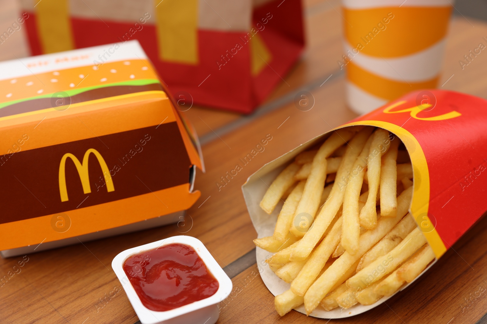 Photo of Lviv, Ukraine - October 9, 2023: McDonald's menu on wooden table outdoors, closeup