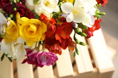 Photo of Beautiful spring freesia flowers on blurred background, closeup