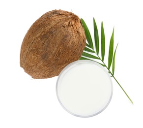 Photo of Glass of delicious vegan milk, coconut and leaf on white background, top view