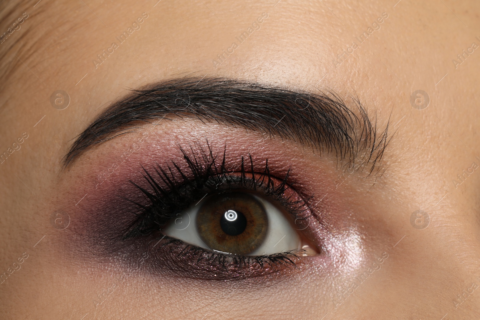 Photo of Young woman with evening makeup, closeup. Eye shadow product